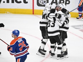 Apr 17, 2023; Edmonton, Alberta, CAN; Los Angeles Kings left winger Alex Iafallo (19 ) along with Kings right winger Viktor Arvidsson (33) celebrate their game-winning goal in overtime against the Edmonton Oilers in the first round of the 2023 Stanley Cup Playoffs at Rogers Place. Los Angeles Kings won the game 4-3.