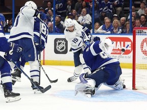 Apr 24, 2023; Tampa, Florida, USA; Toronto Maple Leafs defenseman Morgan Rielly and center John Tavares defends Tampa Bay Lightning left wing Brandon Hagel during the first period of game four of the first round of the 2023 Stanley Cup Playoffs at Amalie Arena.