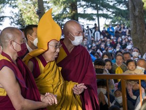 Tibetan spiritual leader the Dalai Lama in a ceremonial yellow hat arrives at the Tsuglakhang temple to give a sermon in Dharamshala, India, Tuesday, March 7, 2023.
