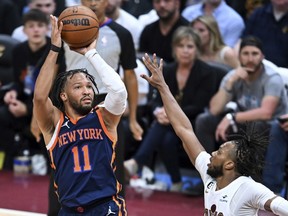 New York Knicks' Jalen Brunson (11) shoots against Cleveland Cavaliers' Darius Garland during the second half of Game 1 in a first-round NBA basketball playoffs series Saturday, April 15, 2023, in Cleveland.