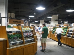 People check out the food options at Augusta National in Augusta, Ga.