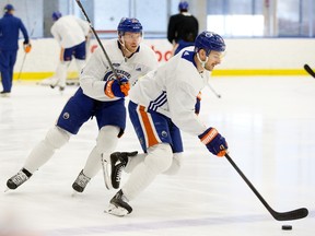 The Edmonton Oilers' Connor McDavid (97) and Zach Hyman (18) take part in a practice ahead of the start of the team's NHL playoff series against the Los Angeles Kings in Edmonton on Sunday, April 16, 2023.