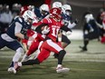 Simon Fraser University Red Leafs Robert Meadors runs the ball downfield while trying to avoid being tackled by Luke Burton-Krahn of the cross-town rivals the UBC Thunderbirds during the 34th Shrum Bowl at SFU Friday, December 2, 2022.