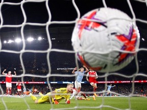 Soccer Football - Premier League - Manchester City v Arsenal - Etihad Stadium, Manchester, Britain - April 26, 2023 Manchester City's Erling Braut Haaland scores their fourth goal past Arsenal's Aaron Ramsdale.