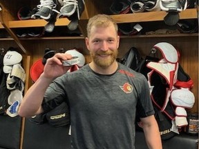 Claude Giroux with the puck he used to score his 1,000th career point.