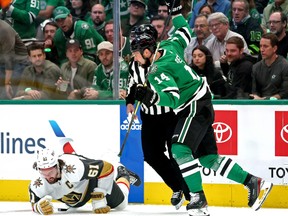Jamie Benn of the Dallas Stars is called for a five-minute major and a game misconduct for a cross-checking penalty against Mark Stone of the Vegas Golden Knights.