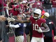 Arizona Cardinals wide receiver DeAndre Hopkins celebrates a touchdown with fans.