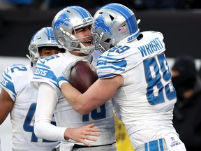 Detroit Lions' Brock Wright and Jared Goff celebrate a touchdown.