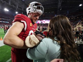 J.J. Watt of the Arizona Cardinals greets his wife and newborn baby prior tot he game against the Tampa Bay Buccaneers at State Farm Stadium on December 25, 2022 in Glendale, Arizona.