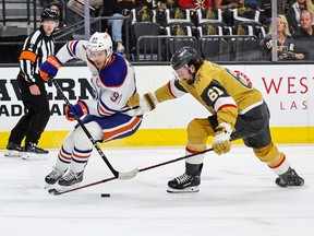 Mark Stone #61 of the Vegas Golden Knights knocks Connor McDavid #97 of the Edmonton Oilers off the puck in the first period of Game One of the Second Round of the 2023 Stanley Cup Playoffs at T-Mobile Arena on May 3.