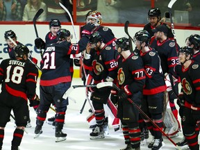 Ottawa Senators winger Claude Giroux (28) is swarmed by teammates as they help him celebrates his 1,000th career point.