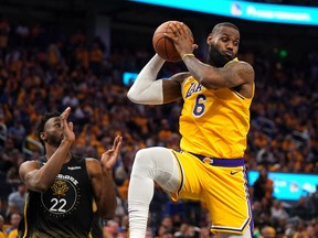 Los Angeles Lakers forward LeBron James (6) grabs a rebound in front of Golden State Warriors forward Andrew Wiggins (22) in the fourth quarter during game one of the 2023 NBA playoffs at the Chase Center on May 2, 2023. Cary Edmondson-USA TODAY Sports