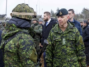 General Wayne Donald Eyre (right), Canadian chief of the Defence Staff, talks with soldiers during a visit of the Adazi military base, north east of Riga, Latvia, March 8, 2022.