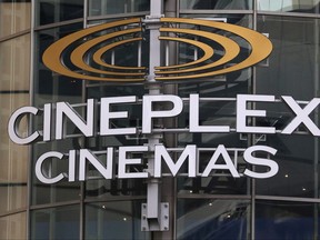 A Cineplex movie theatre sign looms over Yonge Street in Toronto, March 16, 2020.