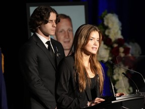 Justyna Pierzchala, the sister of slain OPP Const. Grzegorz Pierzchala, speaks at his funeral service in Barrie on Wednesday, Jan. 4, 2023, as her brother Michal looks on.