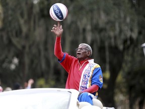 Larry "Gator" Rivers, a member of the Chatham County Commission and a former Harlem Globetrotter, shows off his ball handling skills as he rides in the annual Veterans Day Parade on Thursday, Nov. 11, 2021 in Savannah, Ga.