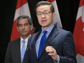 Conservative Leader Pierre Poilievre speaks at a news conference, Tuesday, May 23, 2023 in Quebec City. Conservative MP Pierre Paul-Hus, left, looks on.