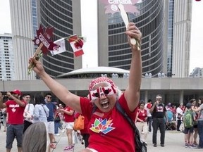 Siony Larggado could not t contain her Canadian spirit at Toronto City Hall on Canada Day on July 1, 2017. The city is cancelling Canada Day celebrations at Nathan Phillips Square this year. (Craig Robertson/Toronto Sun)