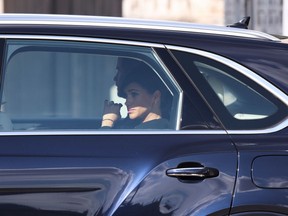 Prince Harry, Duke of Sussex and Meghan, Duchess of Sussex depart in a car after the procession for the Lying-in State of Queen Elizabeth II on September 14, 2022 in London, England. (Photo by Richard Heathcote/Getty Images)