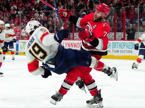 May 18, 2023; Raleigh, North Carolina, USA; Carolina Hurricanes defenseman Jaccob Slavin (74) checks Florida Panthers left wing Matthew Tkachuk (19) during the third overtime period of game one in the Eastern Conference Finals of the 2023 Stanley Cup Playoffs at PNC Arena.