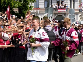 Latvian hockey players Oskars Cibulskis and Karlis Cukste react as thousands of fans gather to greet IIHF World Championship 2023 bronze medalists in Riga, Latvia May 29, 2023.