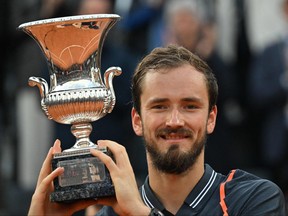 Russia's Daniil Medvedev poses with the trophy celebrating winning the final match of the Men's ATP Rome Open tennis tournament against Denmark's Holger Rune on the central court of Foro Italico in Rome on May 21, 2023.