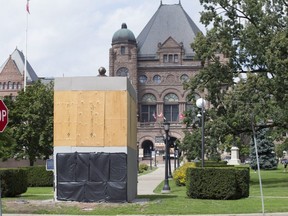 The statue of Sir John A. MacDonald at Queen's Park is wrapped up and surrounded by boards. September 2, 2020. Craig Robertson/Toronto Sun/Postmedia Network