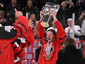 Canada's forward Tyler Toffoli (R) holds up the trophy as they celebrate winning the IIHF Ice Hockey Men's World Championships final match betweeen Canada and Germany in Tampere, Finland, on May 28, 2023.
