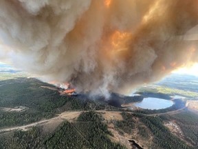 Smoke from an out-of-control fire near Lodgepole, Alta., is shown in this May 4, 2023 handout photo. An out-of-control wildfire has caused thousands of people to flee their homes in Drayton Valley, Alta., and the surrounding rural area.