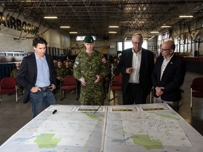 Prime Minister Justin Trudeau (left to right), Colonel Ben Schmidt, MP Randy Boissonnault, and MP Bill Blair meet with members of the Canadian Armed Forces who are assisting in the Alberta wildfires, in Edmonton on May 15, 2023.