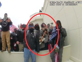 In this image from a Washington Metropolitan Police Department officer's body-worn video camera, released and annotated by the Justice Department in the Government's Sentencing Memorandum, Peter Schwartz, circled in red, is shown using a canister of pepper spray against officers on Jan. 6, 2021, in Washington, D.C.