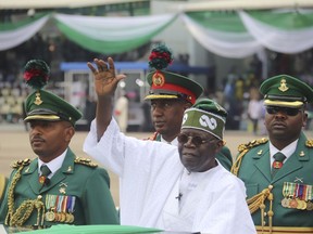 Nigeria's new President Bola Ahmed Tinubu, inspects honour guards after taking an oath of office at a ceremony in Abuja Nigeria, Monday May 29, 2023.
