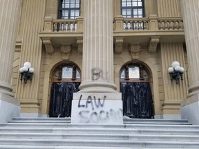 Edmonton police have arrested a 59-year-old man who was seen spray-painting graffiti at the north entrance of the Alberta legislature building on Wednesday, May 10, 2023. When confronted by construction workers, police said the man picked up a firearm and pointed it at the workers. The man was arrested without incident, and two firearms, one loaded, were seized from the scene.