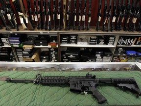 An AR-15 style rifle is displayed at the Firing-Line indoor range and gun shop, Thursday, July 26, 2012 in Aurora, Colo.