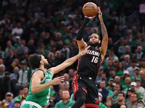 Caleb Martin of the Miami Heat attempts a three-point shot against Derrick White of the Boston Celtics at TD Garden on May 29, 2023 in Boston.
