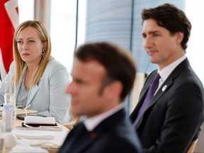 Italian Prime Minister Giorgia Meloni, French President Emmanuel Macron and Prime Minister Justin Trudeau take part in a working lunch session at the G7 Leaders' Summit in Hiroshima, Japan, on Friday, May 19, 2023.