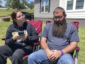 Justin Webster and his wife, Ashleigh, sit outside their Henryetta, Oklahoma, home on Tuesday, May 2, 2023. The couple's daughter, Ivy, 14, was among seven people found slain at a home in Henryetta on Monday.
