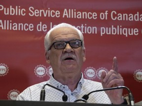 Public Service Alliance of Canada National President Chris Aylward speaks during a news conference at union headquarters, Monday, April 17, 2023 in Ottawa.