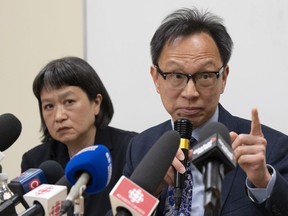 Sen. Yuen Pau Woo denounces RCMP allegations of Chinese government interference in Canada with community organizer May Chiu looks during a news conference at the Service à la Famille Chinoise du Grand Montreal on Friday, May 5, 2023, in Montreal.