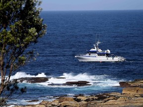 In this file photo, a fisheries boat patrols the site of a fatal shark attack off Little Bay Beach in Sydney on Feb. 17, 2022, as authorities deployed baited lines to try to catch a giant great white shark that devoured an ocean swimmer.