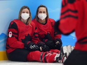 Canadian women's hockey team members Laura Stacey (7), and Marie-Philip Poulin pose for a picture at the 2022 Winter Olympics, Wednesday, Feb. 2, 2022, in Beijing.