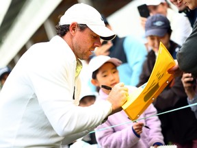 Rory McIlroy of Northern Ireland signs autographs for fans following the Pro-Am of the RBC Canadian Open.