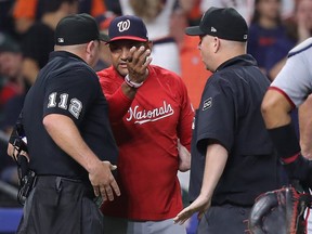 Manager Dave Martinez of the Washington Nationals argues with umpires.
