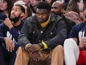 New Orleans Pelicans forward Zion Williamson watches from the bench.