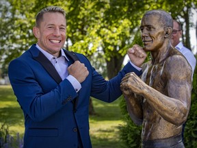 UFC Hall of Famer Georges St-Pierre throws a punch at the life-size statue of himself.