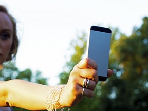 Stock image of woman taking a selfie.