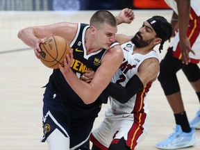 Nikola Jokic, left, of the Denver Nuggets is guarded by Gabe Vincent of the Miami Heat during the fourth quarter in Game 2 of the NBA Finals at Ball Arena on Sunday, June 4, 2023, in Denver.