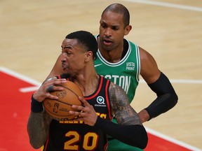 John Collins (20) of the Atlanta Hawks drives against Al Horford (42) of the Boston Celtics during the first quarter of Game 6 of the Eastern Conference First Round Playoffs at State Farm Arena on April 27, 2023 in Atlanta, Ga.