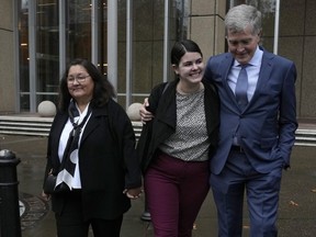 Steve Johnson, right, the brother of Scott Johnson, walks with his wife Rosemarie, left, and daughter Tessa outside the New South Wales Supreme Court in Sydney, Thursday, June 8, 2023.