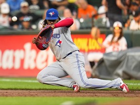 Toronto Blue Jays first baseman Vladimir Guerrero Jr. is unable to make a play on a ball hit by Baltimore Orioles' Anthony Santander during the third inning in Baltimore last night.